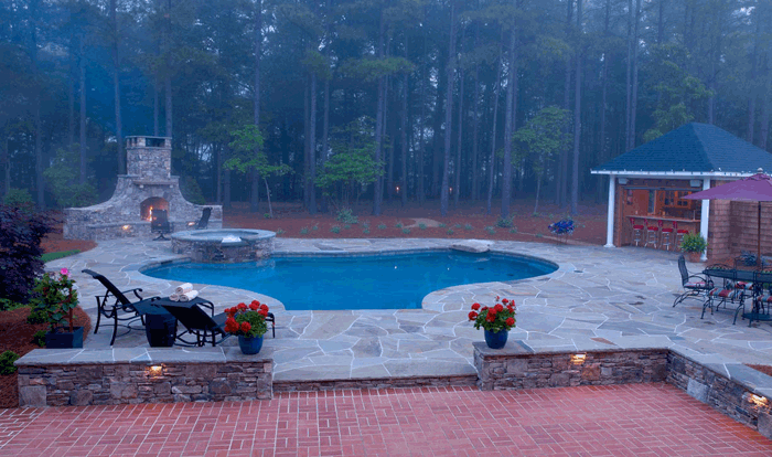 landscape design with swimming pool and outdoor fireplace